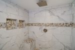 Extra niches and bench in this renovated walk in shower